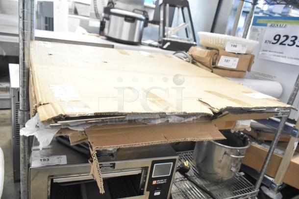 Three brand new scratch and dent items including metal racks, shown packaged. Ideal for resale; signs indicate value increase.