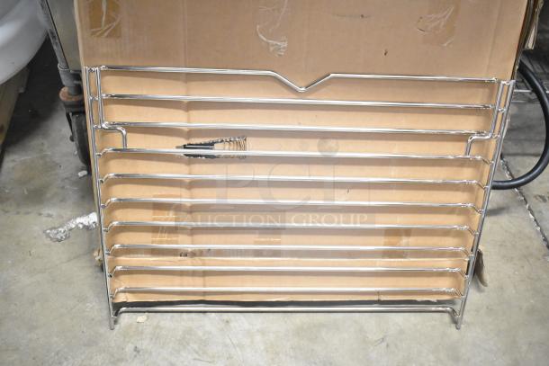 Metal rack, brand new, minor scratches and dents, sturdy chrome design, suitable for storage or display.