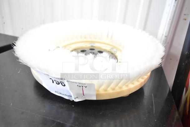 Brand new floor scrubbing machine brush, white bristles, minor scratch and dent, auction tag visible.