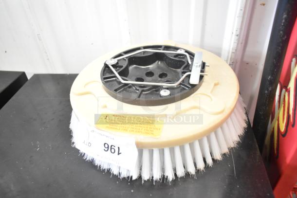 Brand new scratch and dent floor scrubbing machine brush, white bristles, with warning label and auction tag.