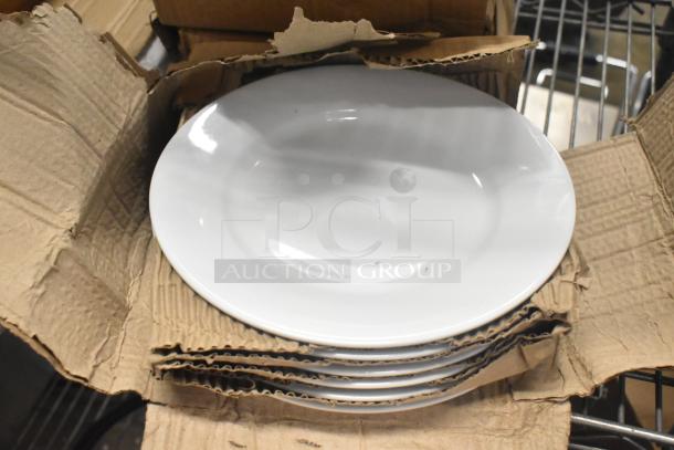 Box of 6 white ceramic plates, brand new with minor scratches and dents, shown in original packaging.