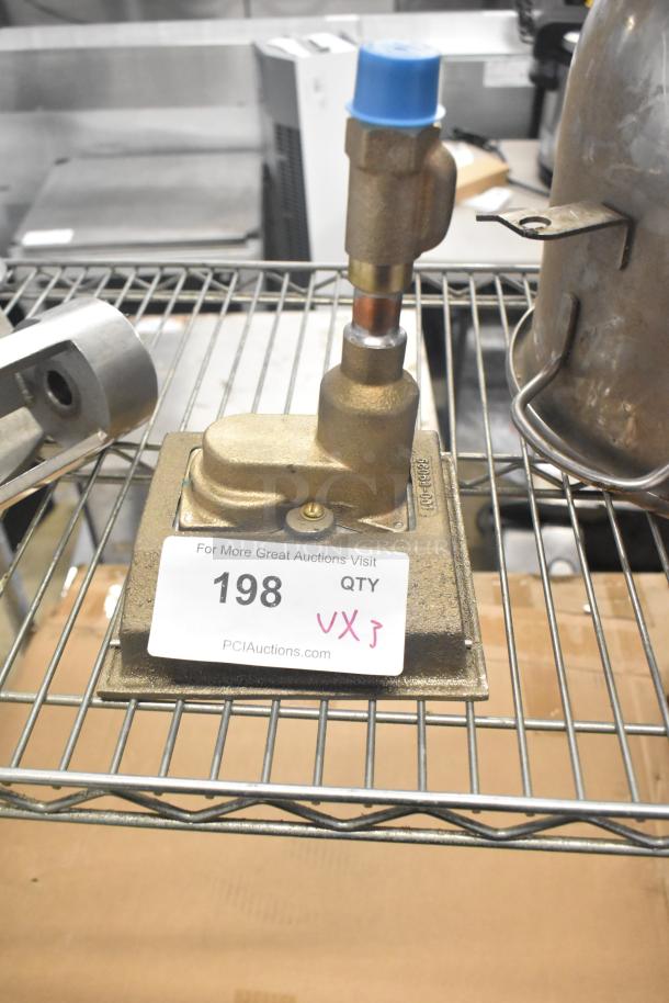 Industrial components including a mixing auger and pelican head front piece on a metal shelf. Auction tag reads "198 QTY."