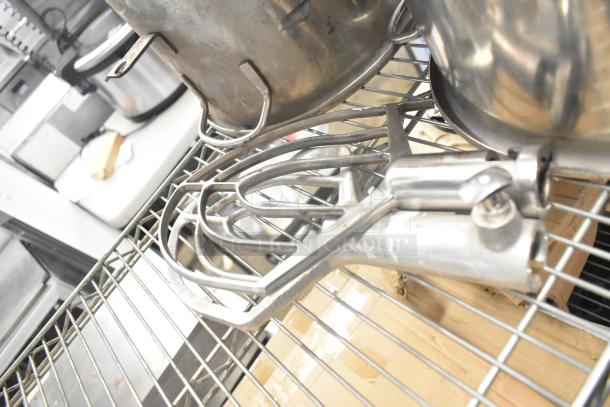 Set of 3 metal mixing bowls and 2 metal paddle attachments on a wire rack. Sturdy, functional condition. Mix and blend efficiently.