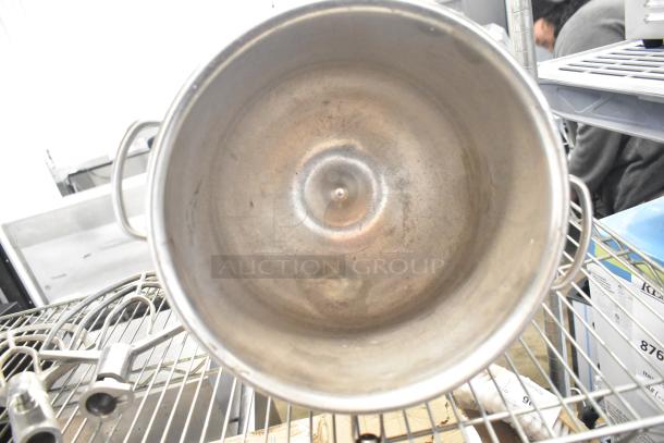 5 kitchen items: 3 stainless steel mixing bowls, 2 metal paddle attachments. Condition shows typical wear.