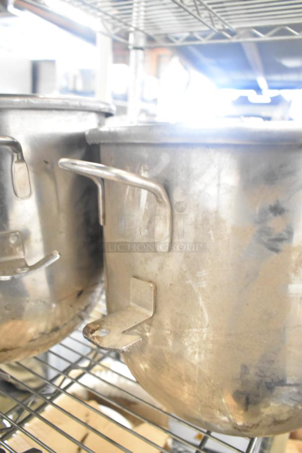 Set of 3 metal mixing bowls with visible handles on a shelf, mild wear, part of a 5-item auction lot.