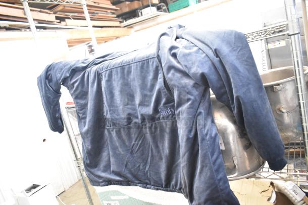 Lot of 2 poly bins with contents; includes a laid-out blue Comfy garment; condition unclear.