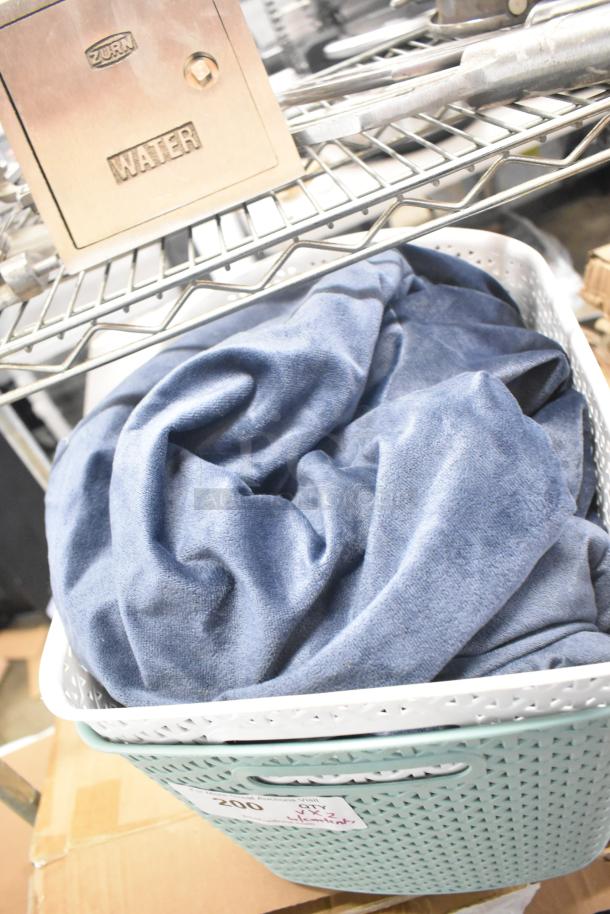 Two poly bins filled, one with a blue fabric, labeled as lot 200. Light wear visible on bins.