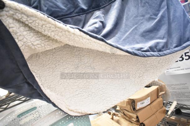 Lot of 2 poly bins with contents, featuring blue fabric cover and cream fleece lining. Includes cardboard boxes with labels.