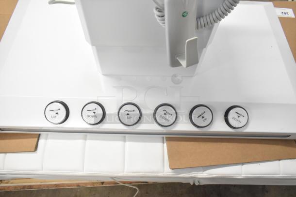 Electronic bed control panel showing buttons for seat positioning adjustments and heat option, in excellent condition.