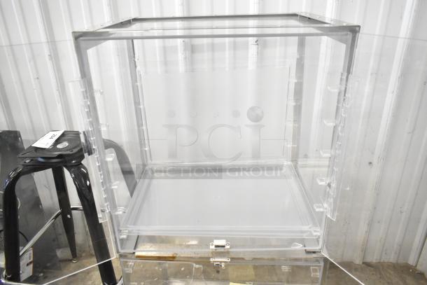 Two clear polycarbonate countertop cabinets, featuring transparent design, hinged doors, and secure locks; excellent condition.