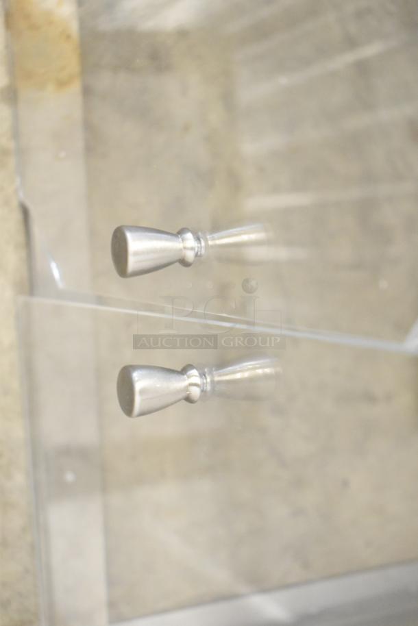 2 clear polycarbonate countertop cabinets with silver handles. Durable and transparent design, ideal for display use.