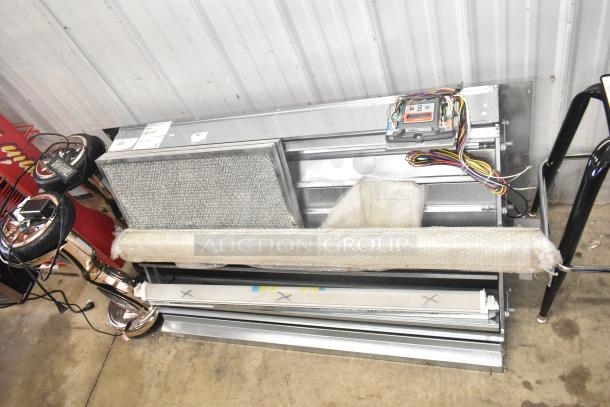 Brand new Daikin hood with McDaniels Metal 122-DK-090 economizer, vertical/downflow, low leak, slight scratches, wrapped in protective bubble wrap.