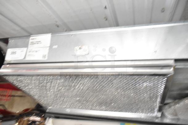 Brand new Daikin hood with McDaniels Metal 122-DK-090 low leak economizer, slight scratches, item tags visible.
