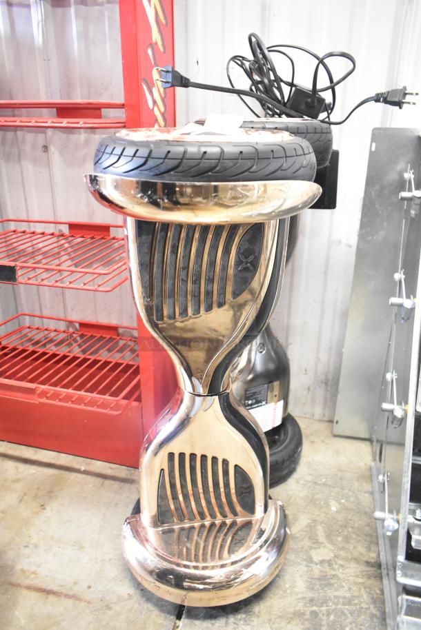 2 Hover-1 Titan HY-TTN Hoverboards, metallic finish, featuring large tires and a durable frame. Chargers included.