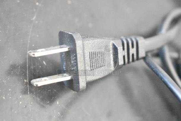 Close-up of a standard two-prong plug on a black power cable, possibly associated with Hover-1 Titan hoverboards.