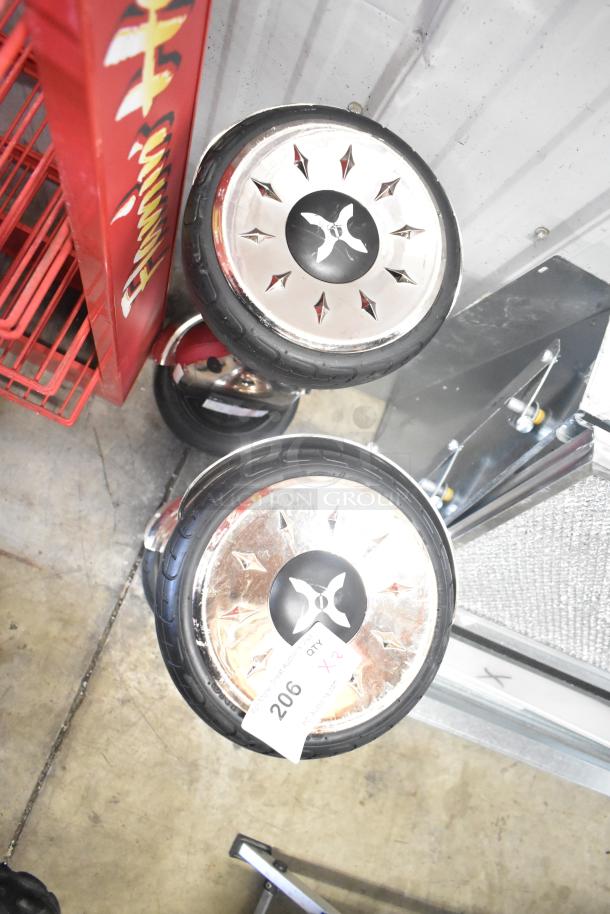 Two Hover-1 Titan HY-TTN hoverboards with chrome wheels, rubber tires, and a tag labeled "206, QTY x2."