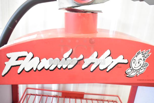 Red Flamin Hot Cheetos metal display shaped like a fire extinguisher, featuring logo and character graphic.