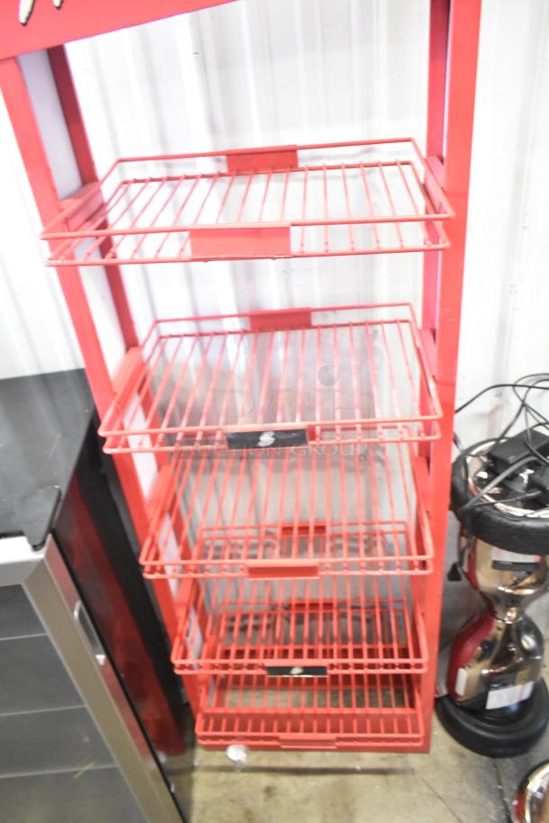 Red metal display rack for Flamin' Hot Cheetos, styled as a fire extinguisher. Four shelves, in good condition.