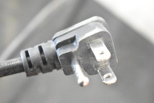 Close-up of a standard plug from the Arctic King ARV115B1AST Mini Cooler Merchandiser, 115 volts, 1 phase.