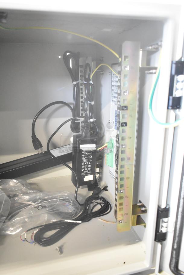 Two BlackShields DC0300 white metal technology cabinets, featuring air conditioning. Clean interior with visible wiring and components.