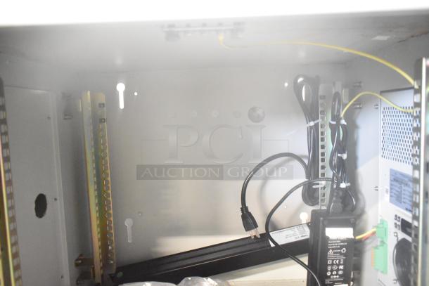 2 BlackShields DC0300 white metal air-conditioned tech cabinets, internal view, showing wiring and components. Good condition.