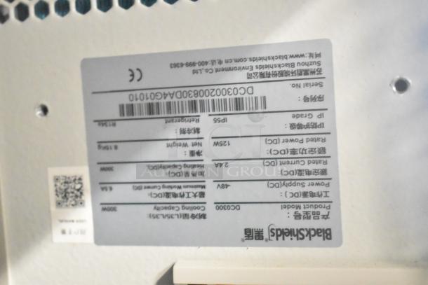 BlackShields DC0300 white metal air-conditioned technology cabinet label, featuring model, power, and cooling details.