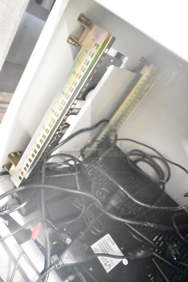 Two BlackShields DC0300 white metal air-conditioned technology cabinets, wiring visible, in good condition.