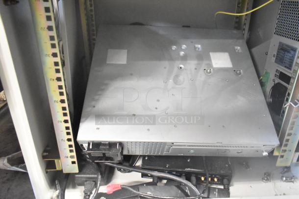 2 BlackShields DC0300 white metal air-conditioned cabinets, shown stacked, with cables and hardware visible.