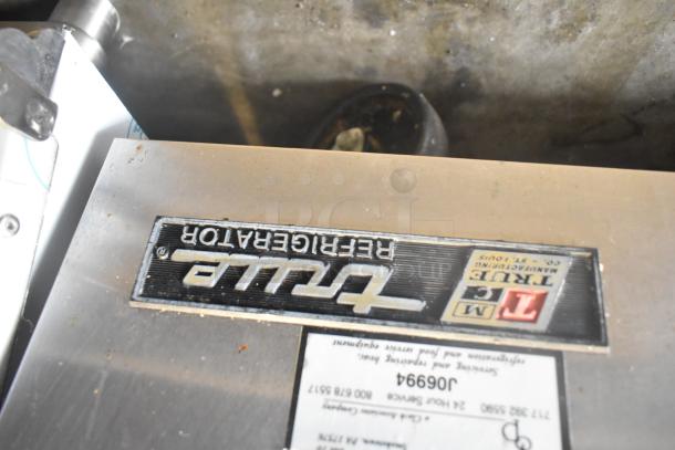 True TWT-60D-4 commercial cooler with stainless steel top, 4 drawers. Visible label with model details. 115 volts, 1 phase.