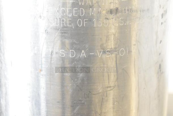 5-gallon keg with visible engravings. Maximum pressure noted as 130 PSI. Scratched metal surface indicates use.