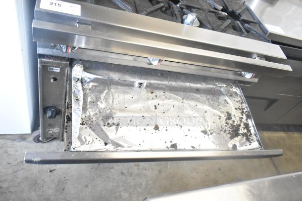 Commercial gas-powered 6-burner range with oven, over shelf, and backsplash. Features commercial casters. Used condition.