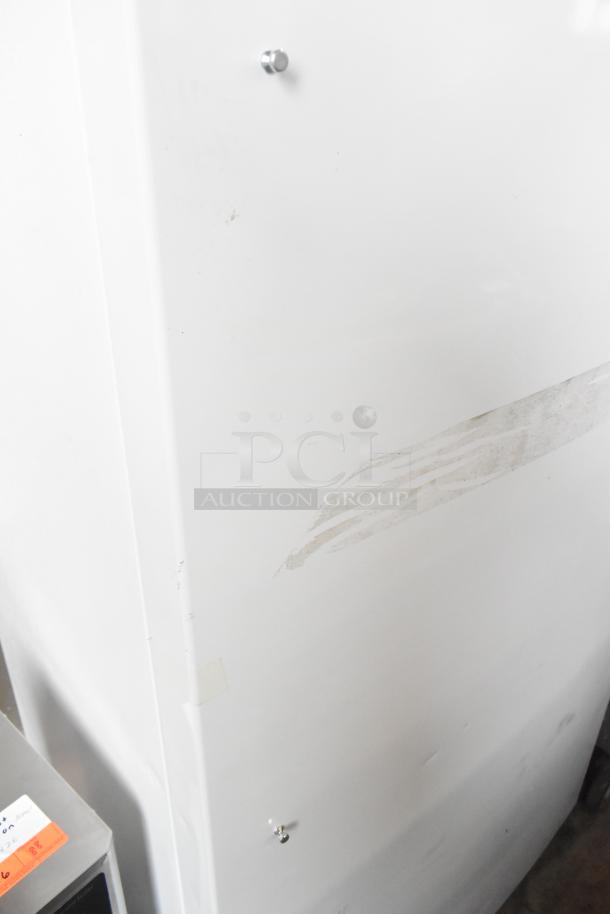 Brand new Frigidaire FRAE2024AWB reach-in cooler; scratch and dent visible; 115 volts, 1 phase.