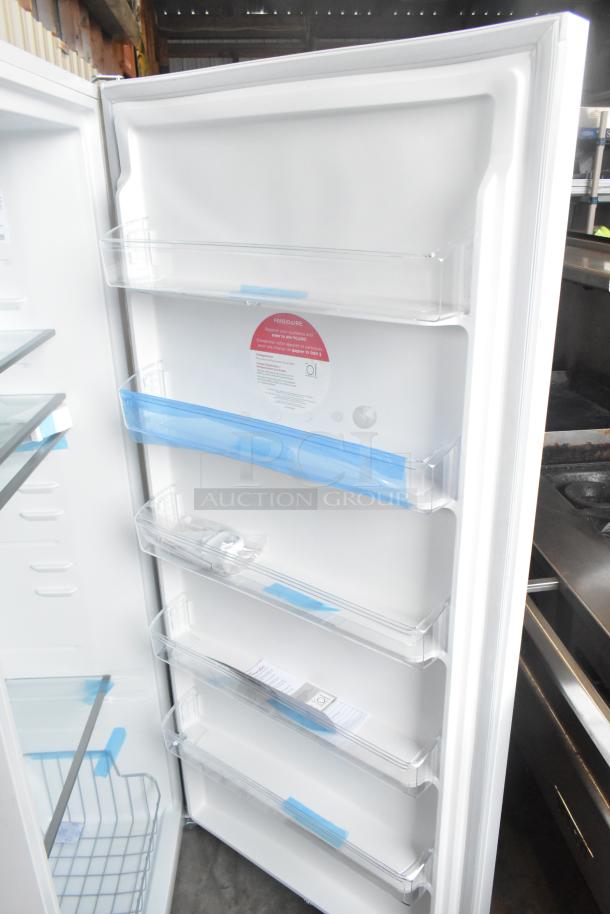 Brand new Frigidaire FRAE2024AWB reach-in cooler, 115 volts, 1 phase. Scratch and dent condition. Interior shelving visible.