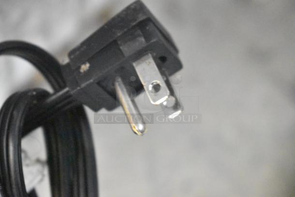 Close-up of power cord for Frigidaire FRAE2024AWB reach-in cooler, showing a three-prong plug. 115 volts, 1 phase.