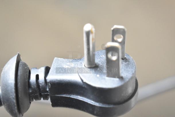 Close-up of a three-pronged power plug attached to the Avantco 178Z1FHC freezer, indicating compatibility with standard outlets.