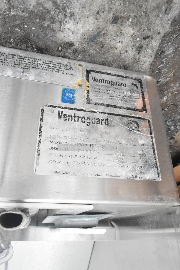 Ventroguard FAC-2 commercial air grease hood, stainless steel, visible wear, NSF label. Model details on metal plate.
