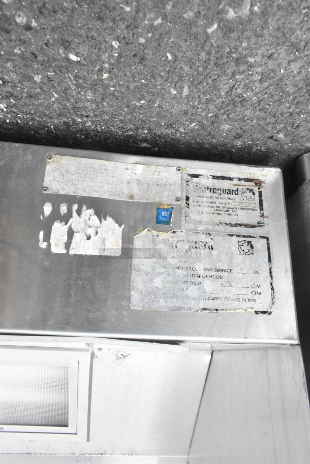 11' Ventroguard commercial grease hood with filters, stainless steel, visible wear, NSF label, model details on worn label.