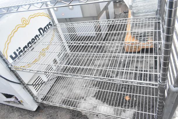 Chrome finish 3-tier wire shelving unit in used condition. Buyer must dismantle. Consider freight charges for shipping.
