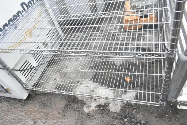 Chrome finish 3-tier wire shelving unit, sturdy construction, visible wear, buyer must dismantle for transport.