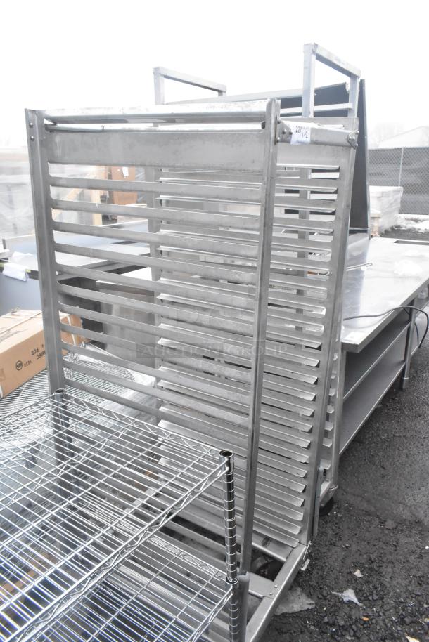 Two commercial pan transport racks with multiple shelves on casters. Durable metal construction, good condition, for kitchen use.