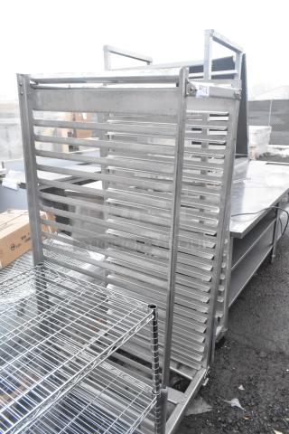 Two commercial pan transport racks with multiple shelves on casters. Durable metal construction, good condition, for kitchen use.