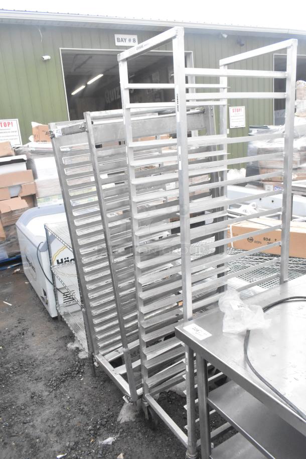 Two commercial pan transport racks with multiple slots and commercial casters, used condition, for auction.