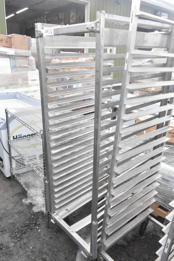 Two commercial pan transport racks on casters, metallic finish, used condition, ideal for bakery or kitchen use.