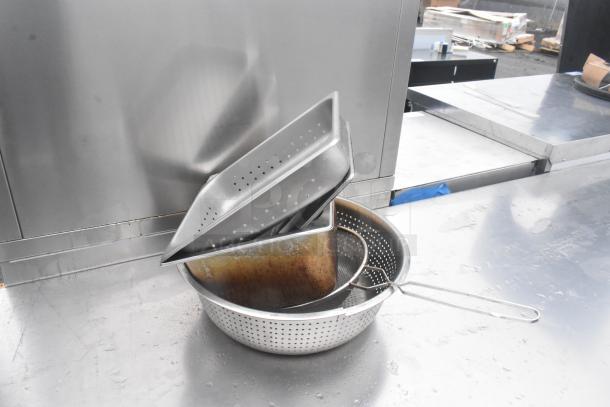 Commercial stainless steel table with two under shelves, used condition, featuring spacious top surface.