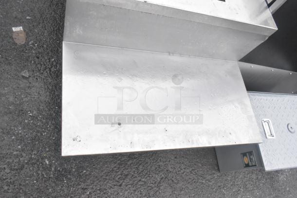 Commercial table with two under shelves, stainless steel, light surface scratches, sturdy construction, suitable for kitchens.