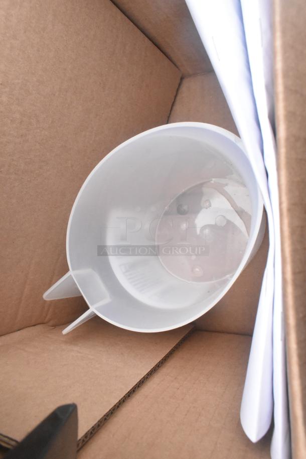 A white plastic container inside a cardboard box, with spouts on either side.