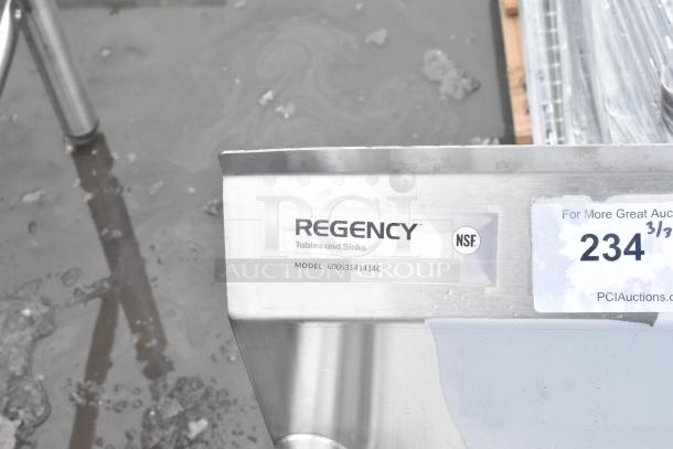 Regency 600S3141414C stainless steel three-compartment corner sink, scratch and dent, no legs, with tags visible.