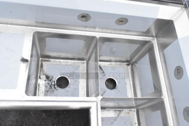 Brand new Regency 600S3141414C 16 gauge stainless steel three-compartment corner sink with two drainboards, no legs, visible scratches.