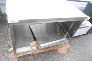 BRAND NEW Regency 30"x48" stainless steel enclosed base table, type 304, sliding doors, adjustable midshelf, minor dents.