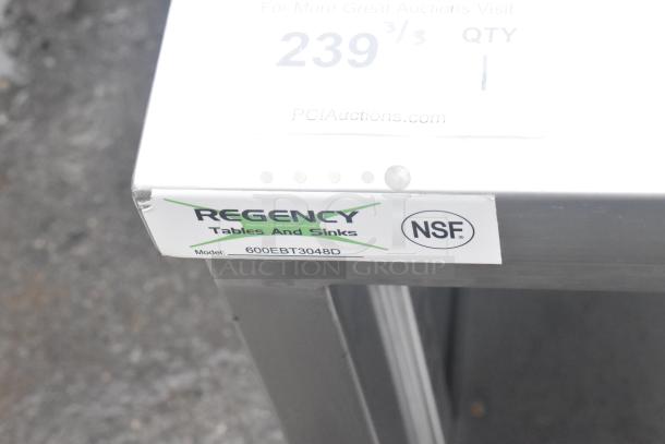 BRAND NEW Regency 600EBT3048D 30"x48" stainless steel table, enclosed base, sliding doors, adjustable midshelf, minor scratches.